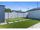 Backyard putting green, block fence and exterior building with artifical grass at 7014 E Latham St, Scottsdale, AZ 85257