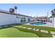 Spacious backyard with a pool, putting green, and covered outdoor seating area at 7014 E Latham St, Scottsdale, AZ 85257