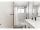 Bright bathroom with white marble tile shower and sleek black fixtures at 7014 E Latham St, Scottsdale, AZ 85257