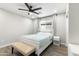 Bright bedroom with a white bed frame, ceiling fan, and wood-look flooring at 7014 E Latham St, Scottsdale, AZ 85257