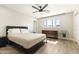 Cozy bedroom with neutral decor, dresser, ceiling fan, and ample natural light at 7014 E Latham St, Scottsdale, AZ 85257
