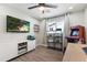 Brightly lit game room with arcade game, media shelving, and ceiling fan at 7014 E Latham St, Scottsdale, AZ 85257