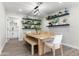 Bright dining room features wood table, bench seating, and stylish shelving with plants at 7014 E Latham St, Scottsdale, AZ 85257