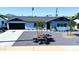 Charming single-story home with a black garage door, well-kept landscaping, and a welcoming entrance at 7014 E Latham St, Scottsdale, AZ 85257