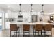 Contemporary kitchen boasts white cabinets, stainless steel appliances, spacious island, and backyard views at 7014 E Latham St, Scottsdale, AZ 85257