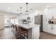 Modern kitchen featuring white cabinets, stainless appliances, island with seating, and backyard views at 7014 E Latham St, Scottsdale, AZ 85257