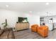 Inviting living room showcasing wood floors, a TV, a couch, and neutral paint at 7014 E Latham St, Scottsdale, AZ 85257