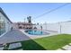 Backyard pool with gazebo, lush green grass, and desert landscaping at 7014 E Latham St, Scottsdale, AZ 85257