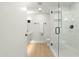 Bathroom with a glass shower, bright white tile, modern fixtures, and light wood flooring at 7137 E Rancho Vista Dr # 5001, Scottsdale, AZ 85251