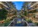 Exterior view of a luxury complex featuring water feature, palm trees, multiple stories, and a courtyard at 7137 E Rancho Vista Dr # 5001, Scottsdale, AZ 85251