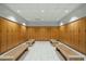 Clean locker room with rows of wooden lockers and benches on tiled floors in community center at 7137 E Rancho Vista Dr # 5001, Scottsdale, AZ 85251