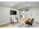 Modern office featuring built-in white cabinets and a light wood desk with a large window at 7137 E Rancho Vista Dr # 5001, Scottsdale, AZ 85251