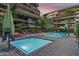 Complex featuring hot tub and a large pool surrounded by lounge chairs and palm trees at 7137 E Rancho Vista Dr # 5001, Scottsdale, AZ 85251