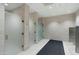Modern and clean restroom with frosted glass stalls and light tile in community center at 7137 E Rancho Vista Dr # 5001, Scottsdale, AZ 85251