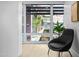 Relaxing sitting area with a cozy chair and a large window offering a glimpse of the lush outdoor surroundings at 7137 E Rancho Vista Dr # 5001, Scottsdale, AZ 85251