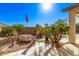 Exquisite backyard landscaping featuring decorative plants, gravel, and stone pathway under a clear sky at 7223 W Saddlehorn Rd, Peoria, AZ 85383