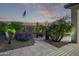 Backyard is landscaped with tropical plants, stone features, and a tiled patio at 7223 W Saddlehorn Rd, Peoria, AZ 85383