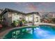 Backyard view featuring pool, covered patio, and lush landscaping, creating a serene retreat at 7223 W Saddlehorn Rd, Peoria, AZ 85383