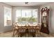 Bright dining room featuring a large window with blinds, traditional furnishings, and tile flooring at 7223 W Saddlehorn Rd, Peoria, AZ 85383