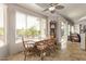 Cozy dining room with tile flooring, ceiling fan, and a view of the backyard through a large window at 7223 W Saddlehorn Rd, Peoria, AZ 85383