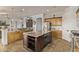 Large kitchen boasts a spacious island, stainless steel appliances, light wood cabinets, and granite countertops at 7223 W Saddlehorn Rd, Peoria, AZ 85383