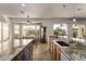 Bright kitchen flows into the eat-in area with an island, granite counters, and backyard views through windows at 7223 W Saddlehorn Rd, Peoria, AZ 85383