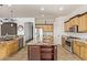Spacious kitchen features an island, stainless steel appliances, granite counters, and light wood cabinetry at 7223 W Saddlehorn Rd, Peoria, AZ 85383