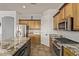Kitchen showcases light wood cabinets, stainless steel appliances, granite countertops, and tile backsplash at 7223 W Saddlehorn Rd, Peoria, AZ 85383