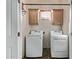 Laundry room features a washer, a dryer, storage cabinets, and a small window at 7223 W Saddlehorn Rd, Peoria, AZ 85383
