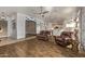 Spacious living room featuring wood-look tile flooring, ceiling fan, and comfortable seating. Open floor plan at 7223 W Saddlehorn Rd, Peoria, AZ 85383