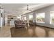 Open-concept living room featuring wood-look tile flooring, ceiling fan, and comfortable seating at 7223 W Saddlehorn Rd, Peoria, AZ 85383