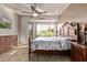 Main bedroom boasts natural light, an exterior door to the backyard, wood-look floors, and modern furniture at 7223 W Saddlehorn Rd, Peoria, AZ 85383