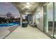 Covered outdoor patio area with ceiling fans, lighting, and a view of the pool at 7223 W Saddlehorn Rd, Peoria, AZ 85383