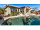 Beautiful swimming pool with lush landscaping, and a covered patio perfect for relaxation at 7223 W Saddlehorn Rd, Peoria, AZ 85383