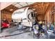 View of the garage with exposed beams and a large RV inside at 7738 N 185Th Ave, Waddell, AZ 85355