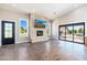 Bright and airy living room with a stone fireplace and large sliding glass doors to the outside at 7738 N 185Th Ave, Waddell, AZ 85355