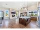 Open-concept living area with a stone fireplace, large windows and a center kitchen island at 7738 N 185Th Ave, Waddell, AZ 85355