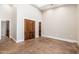 Spacious living room with a high ceiling and stained concrete floors with a wood trimmed sliding door at 7738 N 185Th Ave, Waddell, AZ 85355