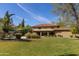 Well-maintained backyard with lush green lawn, mature trees, and plenty of space for outdoor activities and entertaining at 8373 S Forest Ave, Tempe, AZ 85284