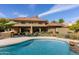 Expansive backyard featuring a pool, lounge chairs, a built-in barbecue, and beautifully manicured landscaping at 8373 S Forest Ave, Tempe, AZ 85284