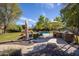 The backyard is complete with a pool, outdoor kitchen, lush landscaping, and comfortable seating areas for relaxing at 8373 S Forest Ave, Tempe, AZ 85284
