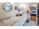 Bathroom with double vanity, modern fixtures, and a view to the adjacent bedroom at 8373 S Forest Ave, Tempe, AZ 85284