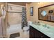 The bathroom features a shower with tile surround, glass shower door, and modern vanity with a stylish mirror at 8373 S Forest Ave, Tempe, AZ 85284