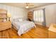 This cozy bedroom features hardwood floors, neutral wall colors, and ample natural light from the window at 8373 S Forest Ave, Tempe, AZ 85284
