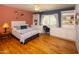 Cozy bedroom with built in desk area, neutral paint, hardwood flooring at 8373 S Forest Ave, Tempe, AZ 85284