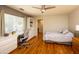 Comfortable bedroom offering hardwood floors, built-in desk, and a bright window at 8373 S Forest Ave, Tempe, AZ 85284