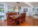 Open dining area with hardwood floors and an elegant light fixture, adjacent to the kitchen at 8373 S Forest Ave, Tempe, AZ 85284