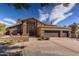 Charming home featuring a stone facade, a circular driveway, and a three-car garage at 8373 S Forest Ave, Tempe, AZ 85284