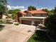 Expansive home featuring a large driveway with a basketball court and a red tile roof at 8373 S Forest Ave, Tempe, AZ 85284