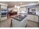 Modern kitchen with white cabinets, stainless steel appliances, and a granite countertop island at 8373 S Forest Ave, Tempe, AZ 85284